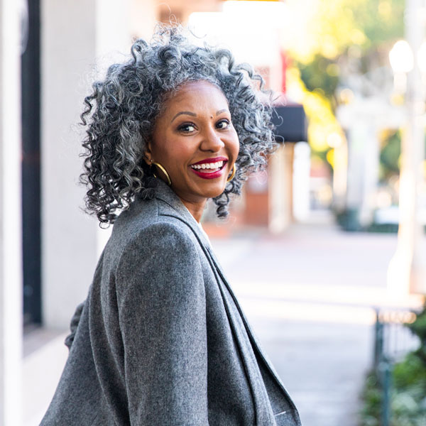 woman smiling and walking away from camera