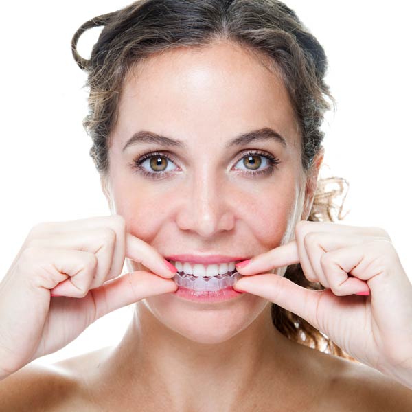 woman putting in Invisalign liner